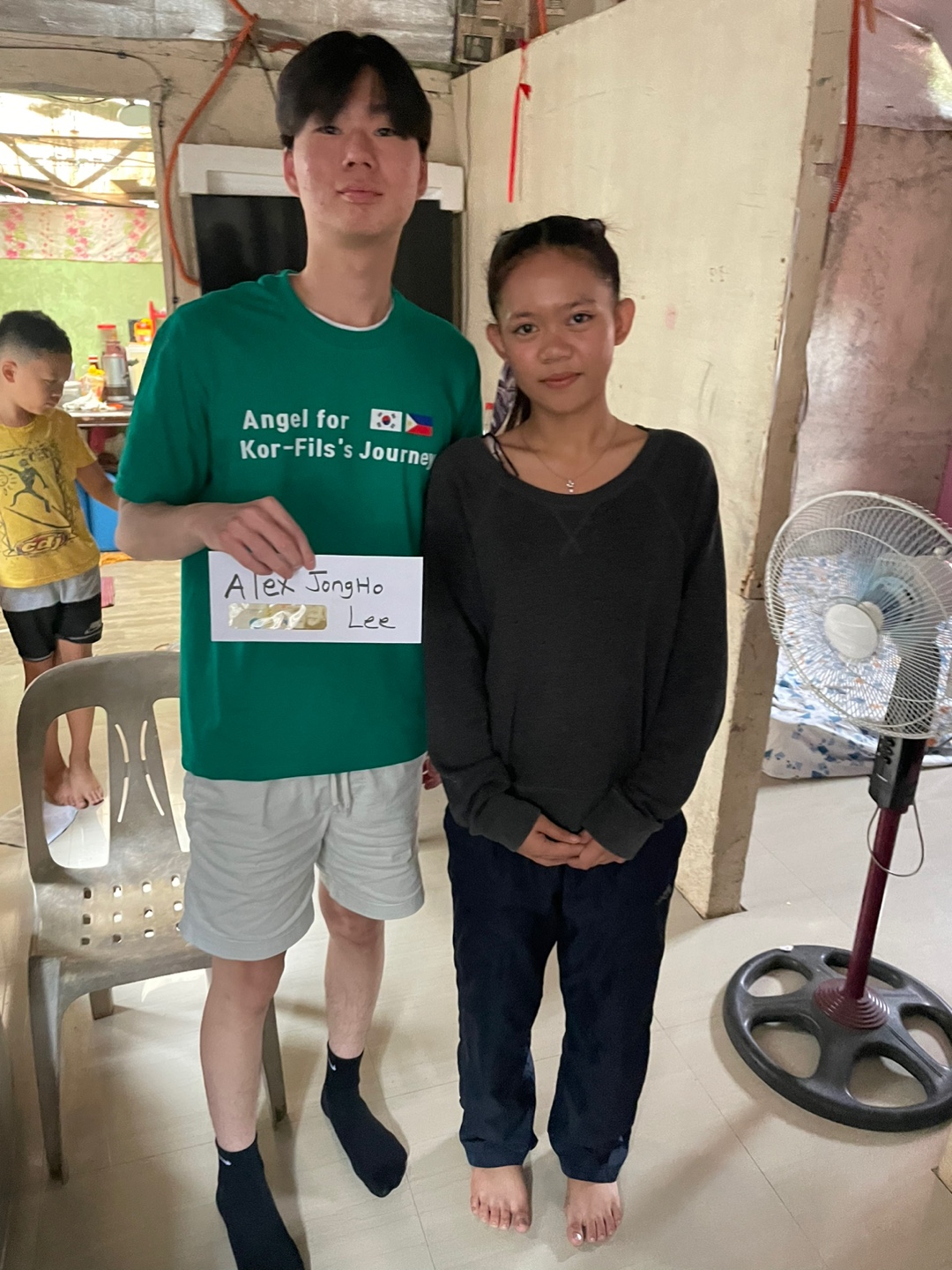 Delivering scholarship support in person to a student in the Philippines.