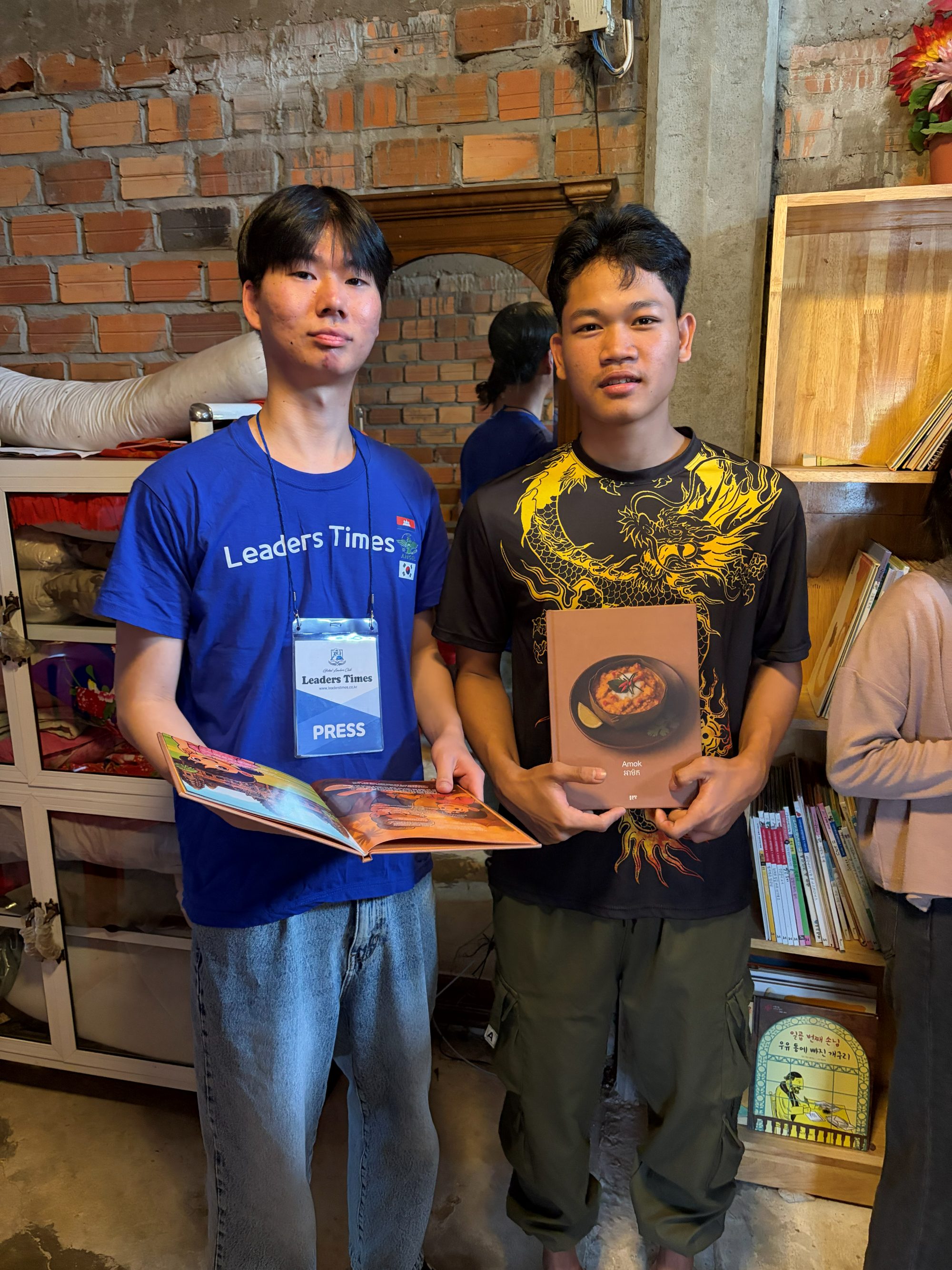 Holding two of the books we published, "Amok" and "Phnom Pros and Phnom Srei," both retellings of Cambodian stories co-written with local youth.